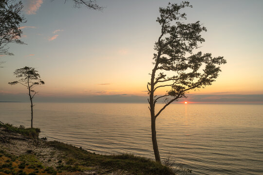 Sunset over the Baltic Sea with sun reflection from coastal cliffs near Rowy, Poland