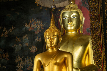 A horizontal interior shot of the sacred golden Phra Phuttha Chinnasi Buddha statue inside Wat Bowonniwet Vihara temple. © Jirakon