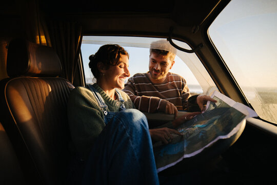 Two friends plan road trip in a vintage van