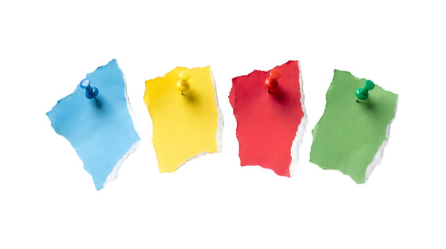 Four colorful torn paper notes pinned with push pins in blue yellow red and green colors