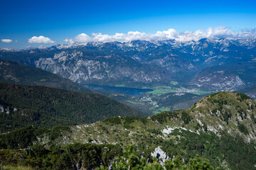 Obraz premium Panoramic view of the Julian Alps and Lake Bohinj from the summit of Črna Prst Mountain in Slovenia