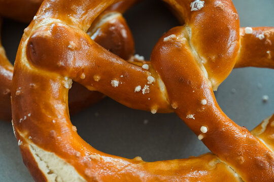 Freshly Baked Salted Soft Pretzels - bavarian lye brown pastry - on Wooden Board