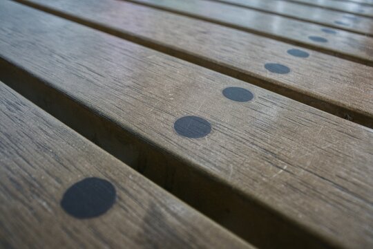 Perspective view of parallel wooden slats pattern on modern park bench surface