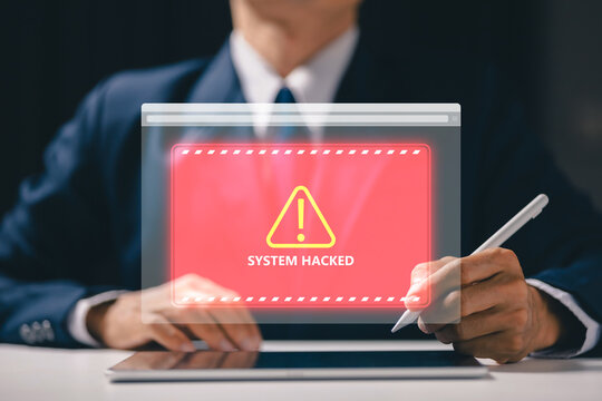 Business professional facing a red system hacked warning on virtual screen, illustrating cybersecurity breach, cyberattack, data security risk, malware threat and digital network protection.