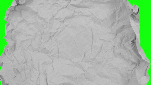 Unfolding and folding crumpled grey paper stop motion isolated on green background. Opening and closing motion.