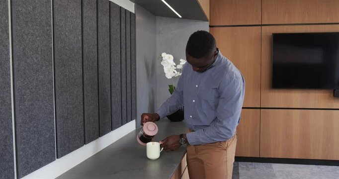 Lifestyle videos indoor of people doing activities at office, preparing coffee, african american mal