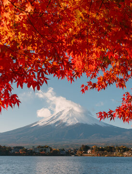 Peaceful view of kawaguchiko lake during autumn season in japan with vibrant autumn maple foliage frame creating serene atmosphere
