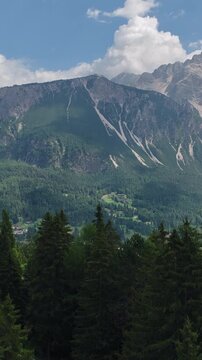 Cortina d&rsquo;Ampezzo, Province of Belluno, Veneto, Italy - A Serene Alpine Valley Surrounded by Lush Forests, Meadows, and the Dolomite Mountains - Vertical Shot