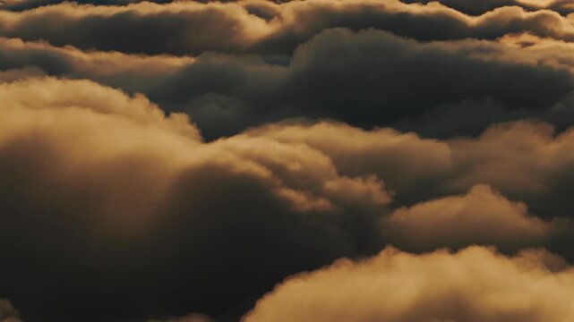Golden clouds rolling over the mountains near Popocatepetl in Izta Popo Zoquiapan National Park, Mexico, at sunrise.