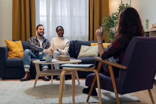 Couple receiving psychotherapy session from female therapist