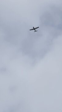 Light sports aircraft flying in the sky on a cloudy day