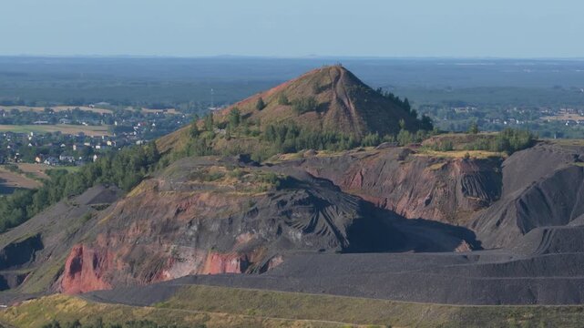 Aerial view of a large coal slag heap from a former mine in a rural landscape