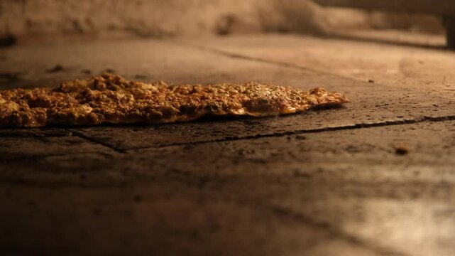 Delicious Turkish Pide, a traditional flatbread, bakes to perfection inside a hot stone oven