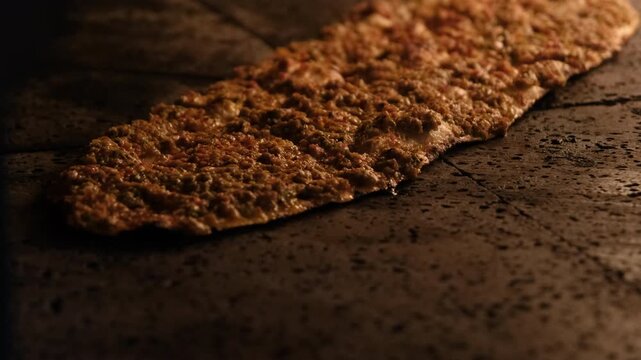 Delicious Turkish Pide, a traditional flatbread, bakes to perfection inside a hot stone oven