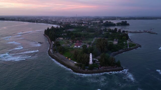 Meulaboh, Aceh : Aerial drone footage of Meulaboh, coastal town in Aceh province of Sumatera in Indonesia. Taken with orbit motion showing light house and crowded town at sunset