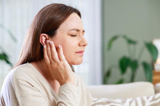 Woman experiencing ear pain