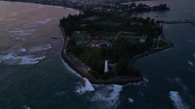 Meulaboh, Aceh : Aerial drone footage of Meulaboh, coastal town in Aceh province of Sumatera in Indonesia. Taken with tilt up motion showing light house and crowded town at sunset
