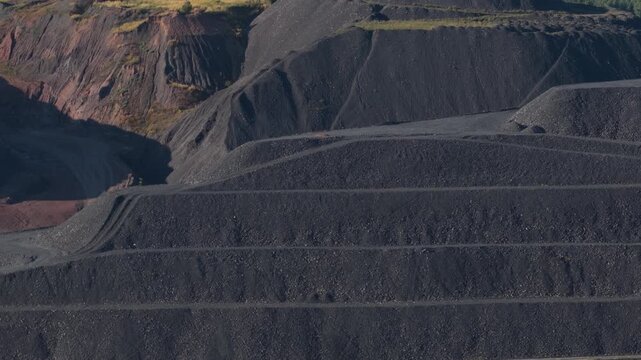 Terraced slag heaps from mining industry revealing environmental impact