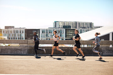 Fototapeta premium Running, group and exercise outdoor with sports, wellness and endurance training for marathon. Runner, people and club with fitness for race preparation, cardio activity and health in urban space