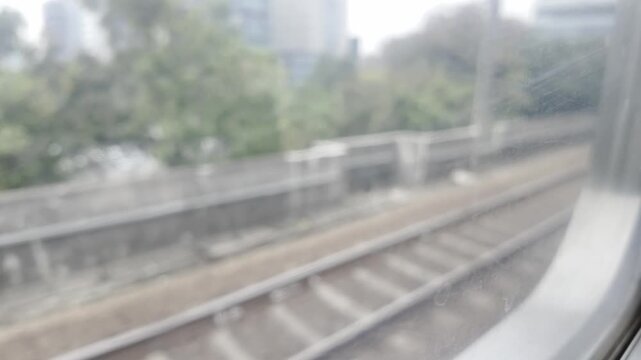 Passenger looking out the window of a moving train.