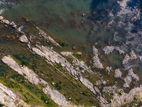 Aerial View of Rugged Rock Formations in a Clear Turquoise River During Morning in Wangon, Central Java, Indonesia. Natural Rocky Features and Pristine Water River Landscape Viewed from Above.