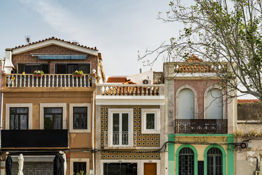 View of traditional Portuguese buildings with ornate tiled facades, wrought iron balconies, and architectural details in Setubal, Setubal, Portugal.