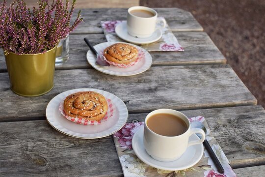 Cinnamon bun (kanelbulle) with coffee.Traditional Swedish fika - a coffee break with pastries.Coffee break.