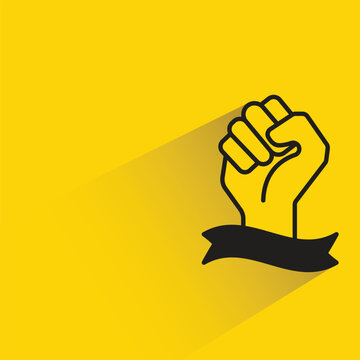 raised fist and ribbon icon with shadow on yellow background