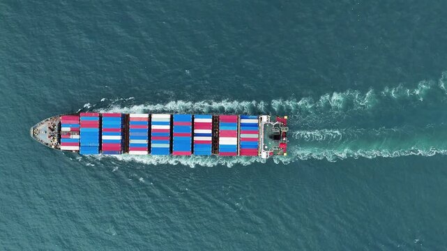 Aerial top view of cargo ship with contrail in the ocean sea ship carrying container and running from container international port smart freight shipping by ship service