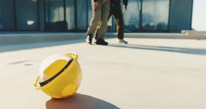 People, builder and helmet with injury on construction site for medical emergency or assistance. Men, contractor or hard hat with labor worker in pain for building accident, fall or danger on space
