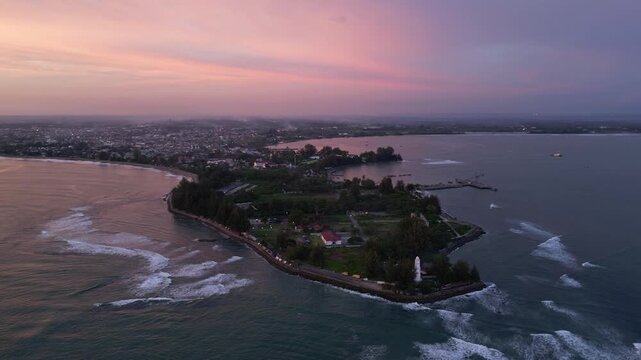 Meulaboh, Aceh : Aerial drone footage of Meulaboh, coastal town in Aceh province of Sumatera in Indonesia. Taken with orbit motion showing light house and crowded town at sunset