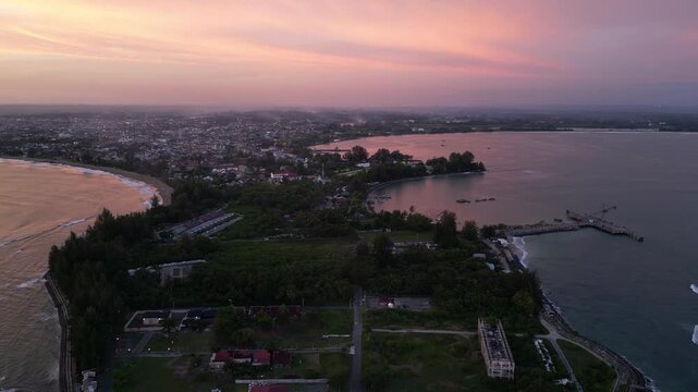 Meulaboh, Aceh : Aerial drone footage of Meulaboh, coastal town in Aceh province of Sumatera in Indonesia. Taken with backward motion showing light house and crowded town at sunset