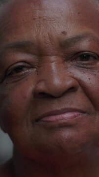 African American elderly person looking directly forward outside with steady dignified eyes conveying profound maturity and unshakeable fortitude