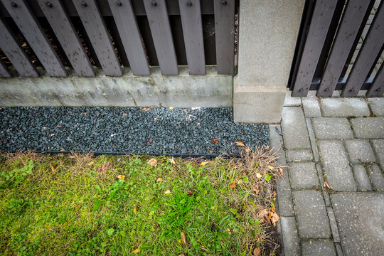 Gravel Drainage Border Beside a Wooden Garden Fence