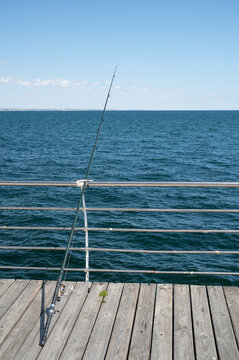 fishing rod and fish on a pier in the sea