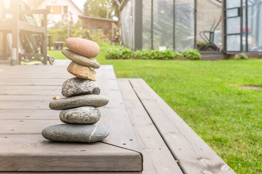 Balanced Stone Cairn in a Sunlit Garden Setting