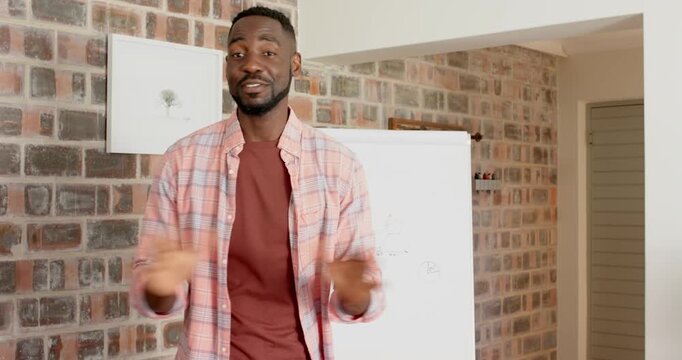 Lifestyle videos indoor of people doing activities at home, smiling man standing and gesturing in fr