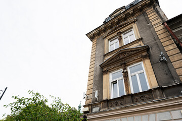 Ornate historic building facade in Radom, Poland with classical sculpture and detailed cornice on an overcast day showing urban architecture and heritage exterior © AS Photo Family