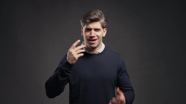Irritated man showing what gesture, Gesturing Disbelief, Asking What Mad. Quarreling handsome guy isolated on grey background. Indignant expression, blaming someone.