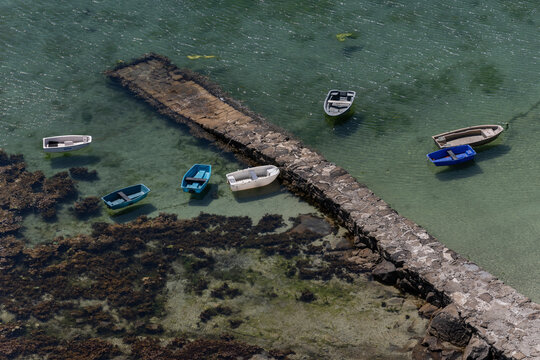 Barcas en embarcadero de la costa de aguas cristalinas 