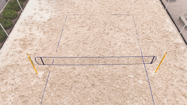 Aerial view of a beach volleyball court with sand surface and net in Riga, Latvia.