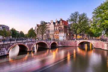Illuminated Amsterdam Canal Houses and Bridge at Sunset © romanslavik.com