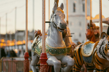 Christmas carousel with colorful animal figures at Cathedral Square in Vilnius, Lithuania. Festive amusement ride and holiday lights create a cheerful winter atmosphere. © MNStudio