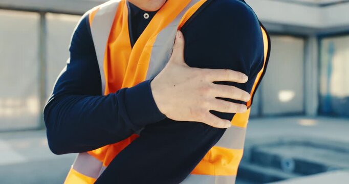 Hands, engineer and discomfort at site with pain, arm sprain and burnout of construction injury. Man, massage and inflammation at worksite with arthritis, shoulder strain and incident of architecture
