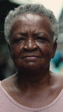 African American elderly woman close portrait at outdoor street market conveying strength dignity and lived experience within everyday local food commerce