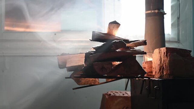 Warm light dances through wooden logs stacked near a chimney