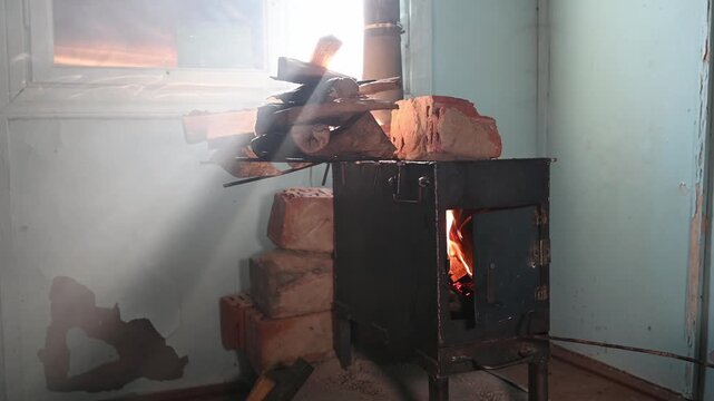 Warmth and light emerge from a cozy wood stove on a chilly morning