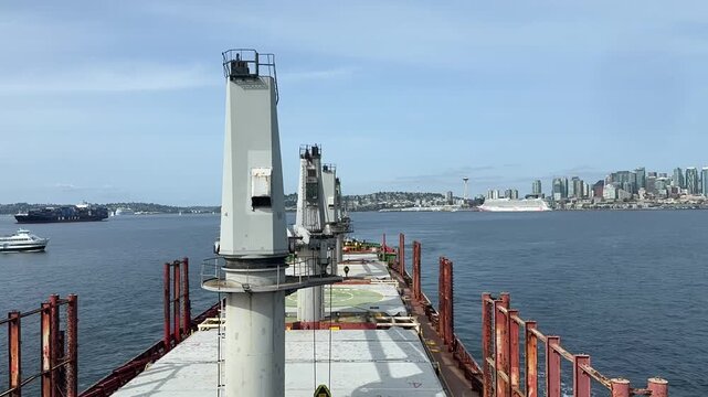 Time-lapse footage of a dry bulk carrier shifting from anchorage to its assigned berth at the Port of Seattle, Washington, USA. The vessel proceeds through harbour waters during port arrival and berth
