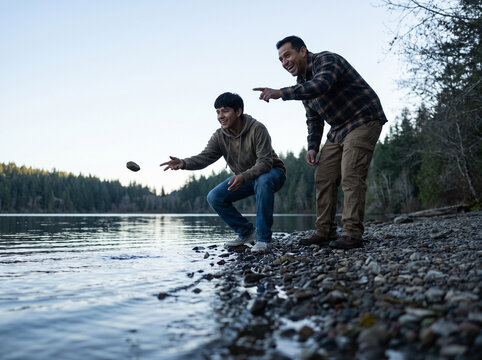 Father and son at a lake throwing rocks
