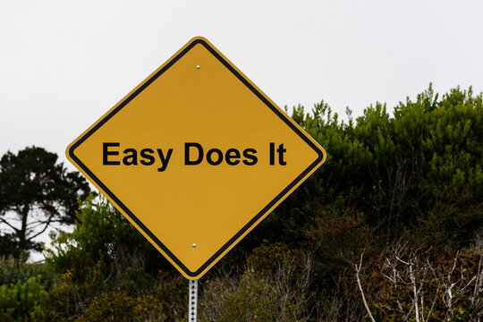 Easy Does It. Alternative yellow caution sign urging passersby to slow down, relax and go a little bit slower through life.